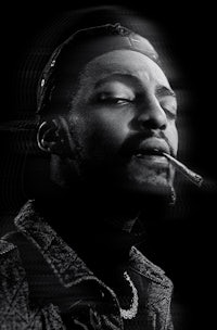 a black and white photo of a man smoking a cigarette